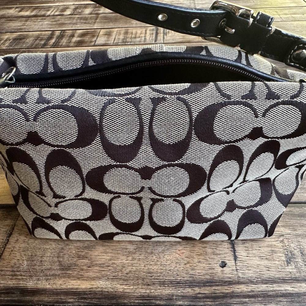 Classic small Coach clutch that is practically new.